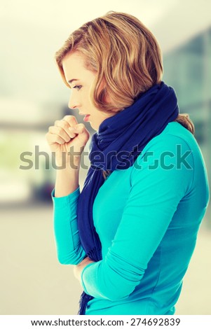 Young woman coughing because of flu