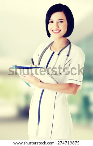 Attractive medicine student or doctor with notebook.