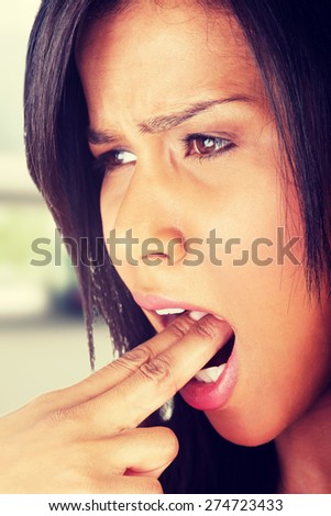 Sick woman with fingers in mouth