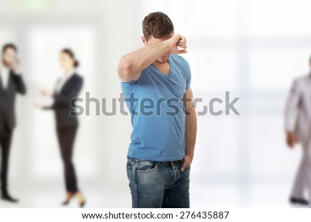 Handsome young depressed man crying.