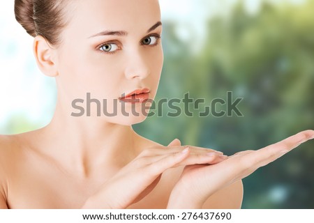 Beautiful spa woman with cream on hand