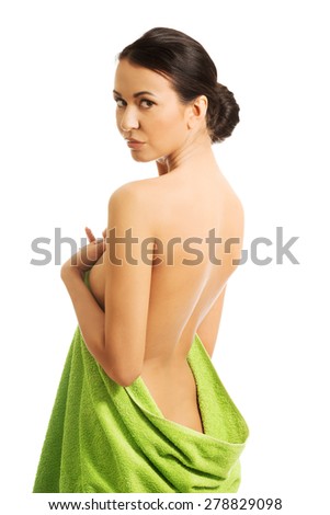 Back view woman wrapped in towel.
