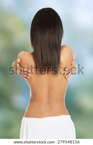 Spa woman from the back wrapped in towel.