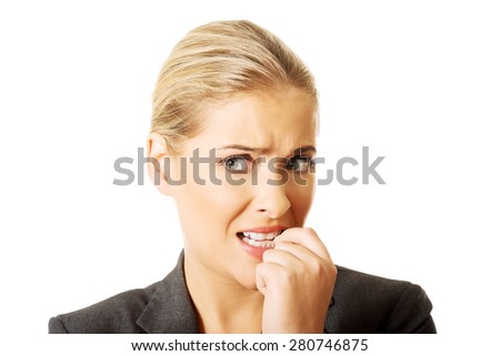 Stressed young woman biting her nails.