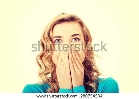 Woman giggles covering her mouth with hand
