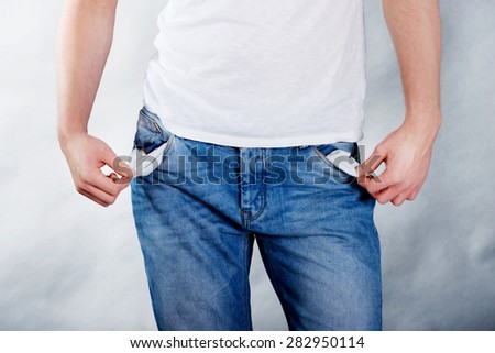 Young poor man with empty pockets.
