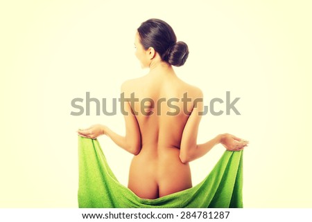 Back view woman wrapped in towel showing her bum.