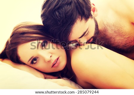 Young love couple in bed, romantic scene in bedroom.
