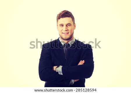 Successful confident businessman with folded arms.