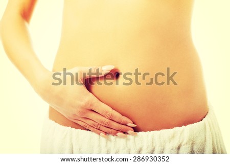 Woman touching her slim belly.