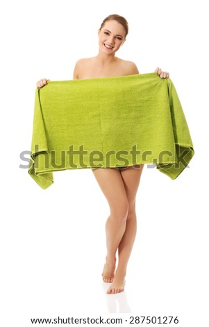 Beautiful spa woman covering herself with a towel.