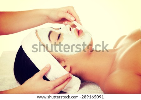 Relaxed woman with  a deep cleansing nourishing face mask applied to her face, beauty and skincare concept