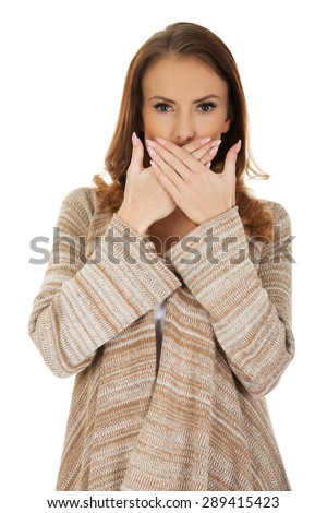 Beautiful woman covering mouth with her hand.
