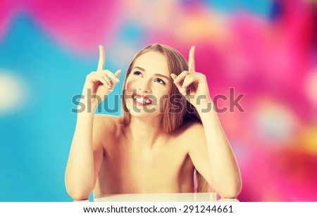 Young nude woman pointing on something