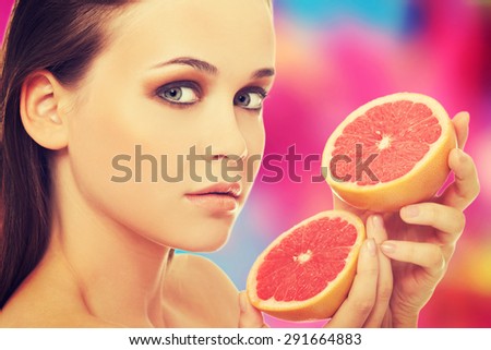 Beautiful brunette with red grapefruit