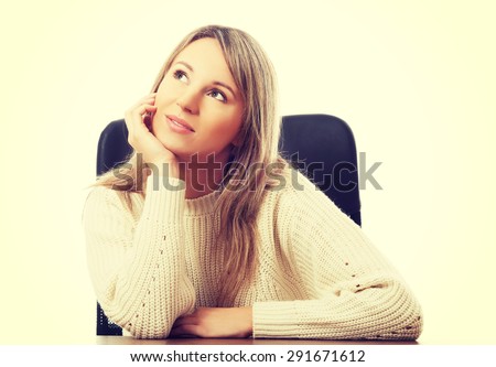 Young beautiful woman sitting at work