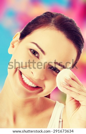 Happy woman removing make up