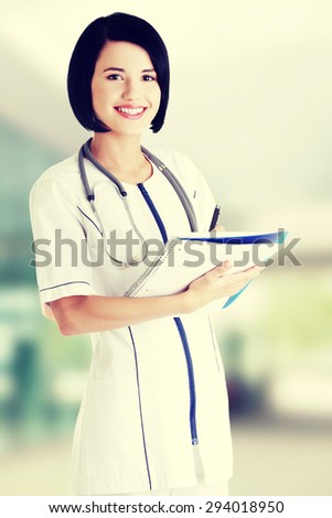 Attractive medicine student or doctor with notebook.