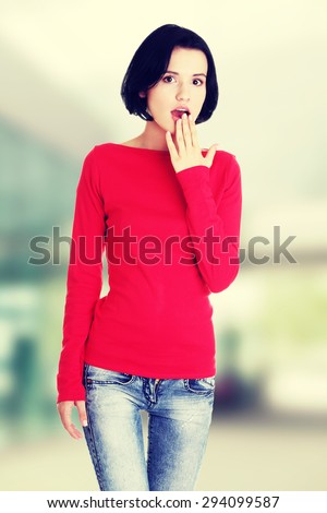 Young woman covering her mouth.