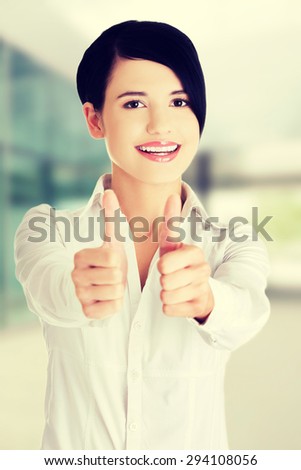 Happy smiling woman thumbs up