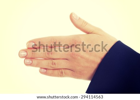 Young businesswoman shaking hand to welcome someone