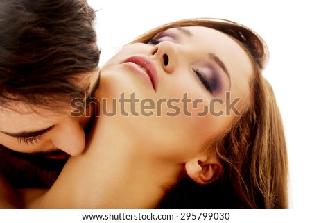 Handsome man kissing woman\'s neck with desire.