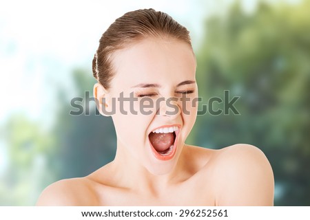 Angry topless woman scream loud.