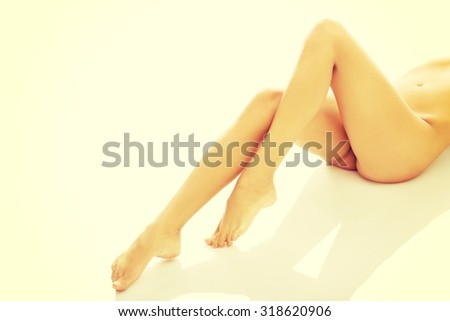 Female nude legs, buttock and slim belly.