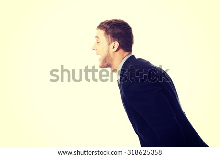 Frustrated businessman screaming on someone.