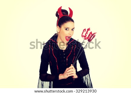 Beautiful woman in devil carnival costume.