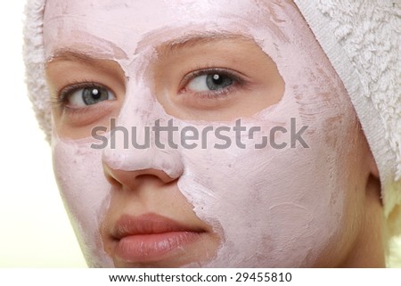 Portrait of a styled model with facial cream mask.