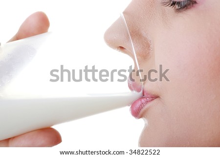 Young happy woman drinking milk isolated on white background
