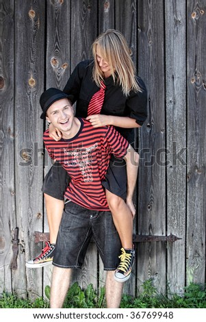 Punk couple against wood wall - street fashion