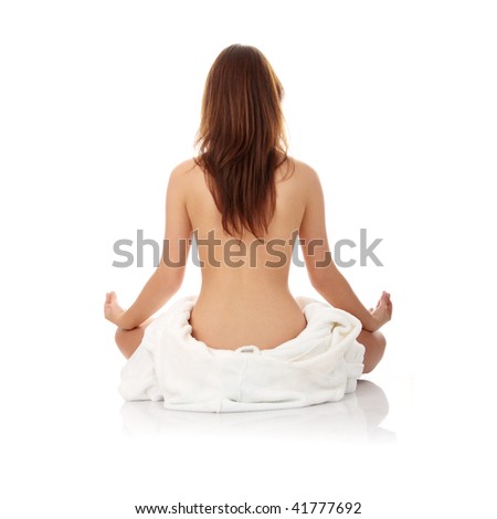 Young beautiful woman topless, in towel, view from back, isolated on white background