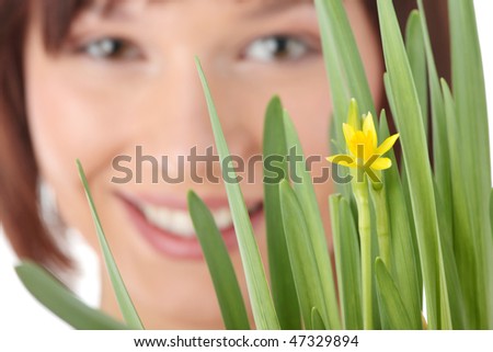 Spring girl with flower portrait, over white background - focus on flower