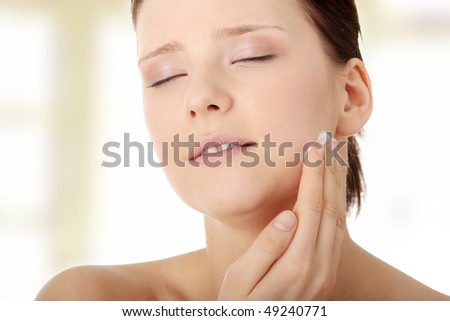 Woman applying moisturizer cream on face. Close-up on woman face.