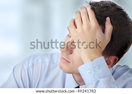 Businessman in depression with hand on forehead