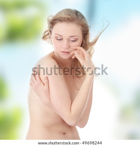Sensual portrait of nude beautiful young blond caucasian woman, with tears in her eyes and wind in her hairs