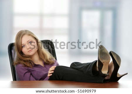 Young beautiful business lady having a rest at the working place.