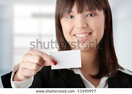Portrait of a beautiful businesswoman holding a white card - focus on card