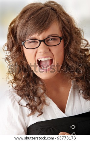 Young caucasian woman (student) screaming with anger