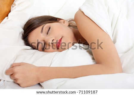 Beautiful young woman sleeping on bed in her bedroom at home