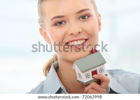 Young beautiful business woman with house model - real estate