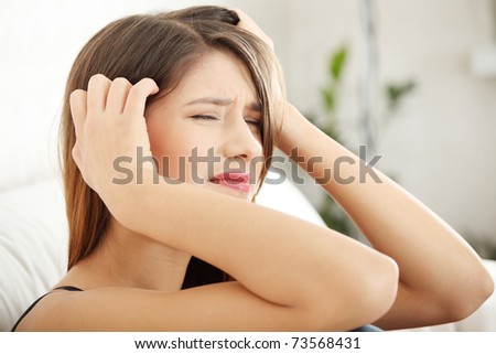 Woman at home with terrible headache or big problem