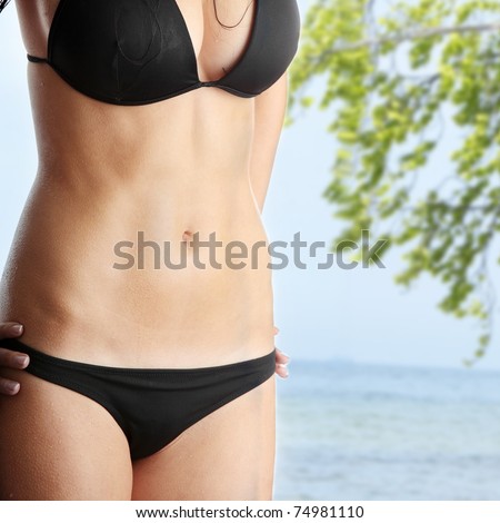 Beautiful wet caucasian woman in black bikini