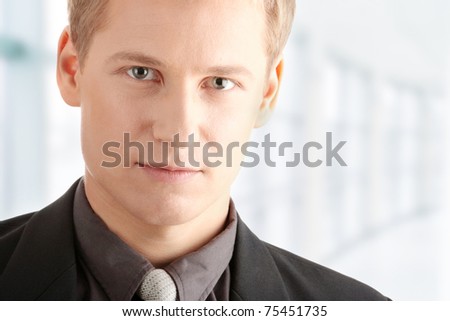 Closeup of a smart handsome business man over white background