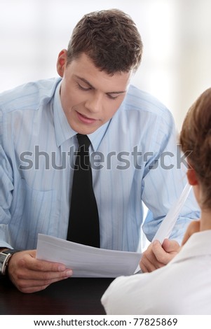 Business coaching concept. Young woman being interviewed for a job.