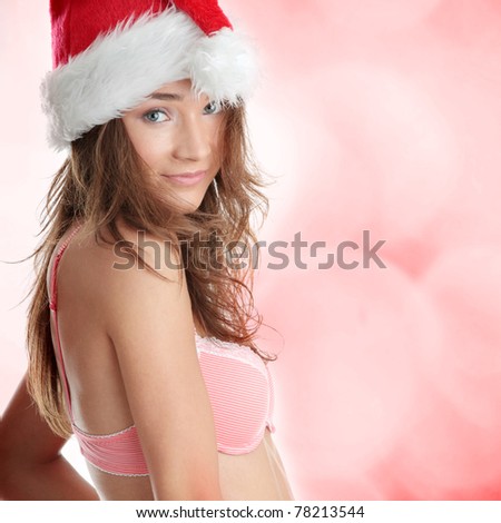 Beautiful,slim, fit and sexy Caucasian woman in pink underwear and santa hat