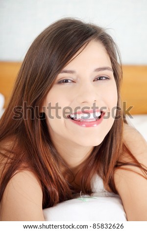 Happy, young, beautiful woman on bed have fun