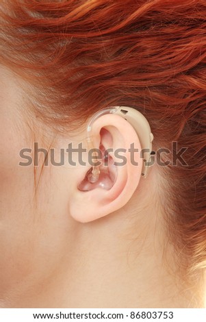 Redhead woman wearing hearing aid